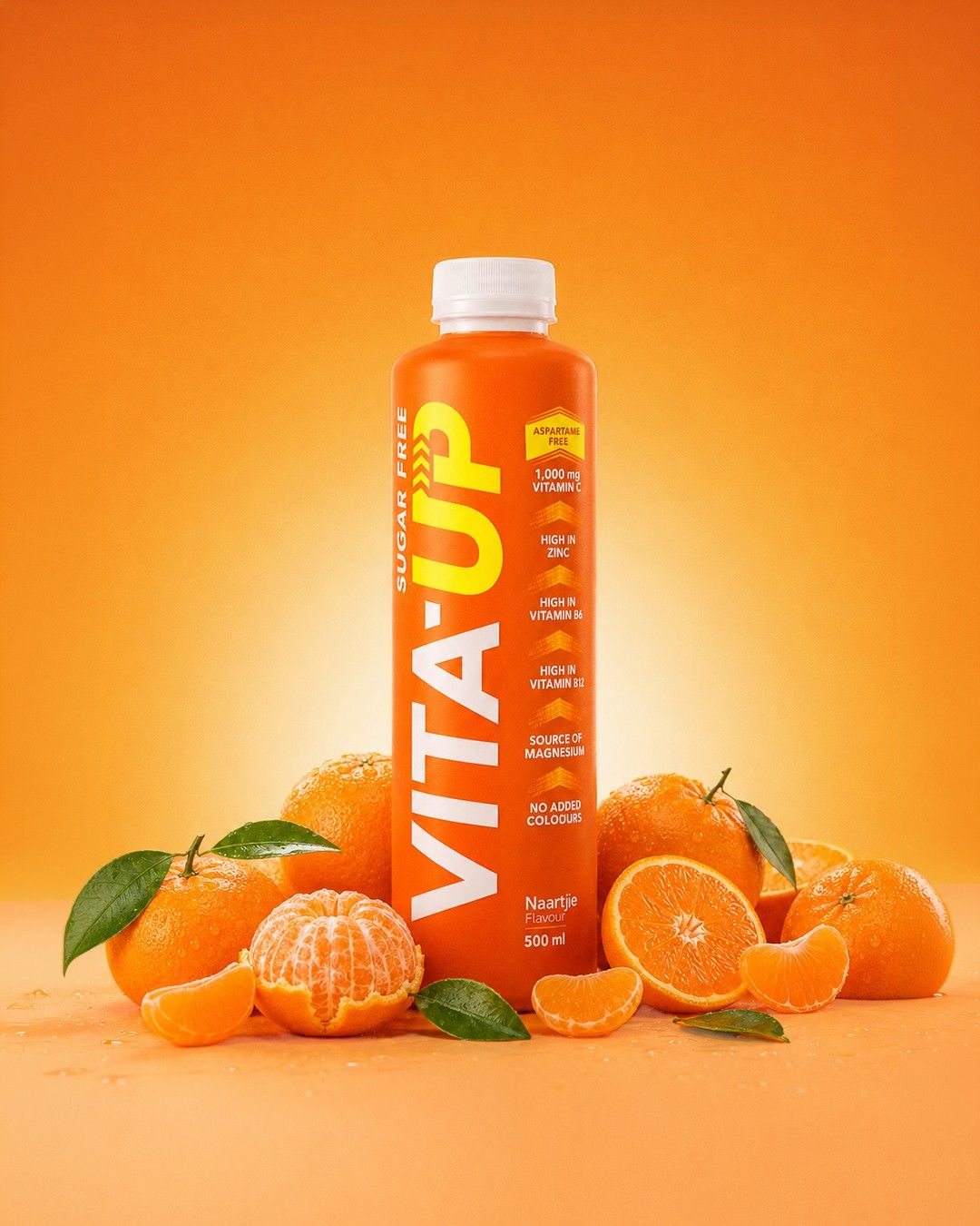 A Naartjie bottle of Vita-Up between peeled naartjies on an orange backdrop
